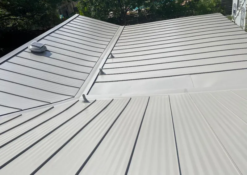 Solar attic fan installed on a metal roof for Roof Ventilation in Sleepy Hollow