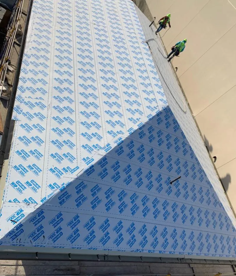 Professional roofers installing underlayment on a metal roof in Sleepy Hollow